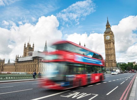 Red double-decker bus on the Westminster Bridge