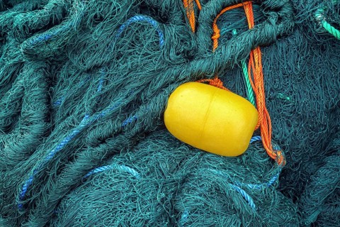 Green fishing net with yellow float