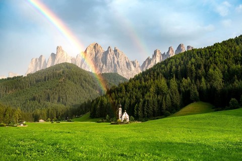 Rainbow in front of the church St. Johann in Ranui