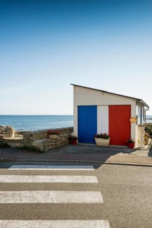 Garage by the sea painted in French national colours