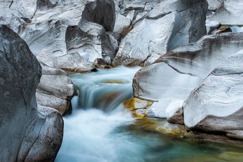 The Verzasca River flows through rocky landscape
