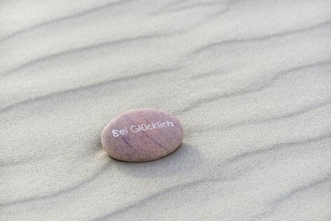 Be Happy inscribed in small stone