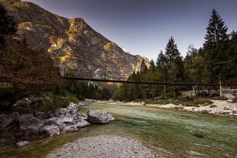 Bridge over Isonzio river in autumn mood in Triglav National Park