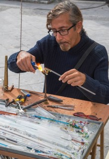 Man creating glass jewelry