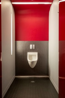 Urinal in modern public toilet nicely illuminated