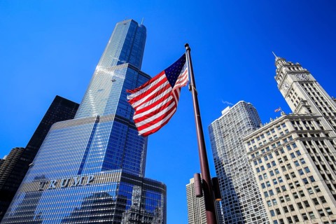 American flag in front of Trump Tower Chicago and Wrigley Building