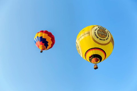 Two hot air balloons rising into the air