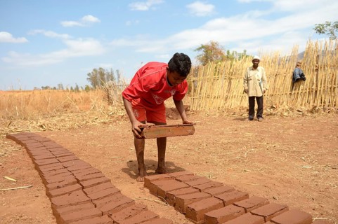 Teenager manufacturing bricks