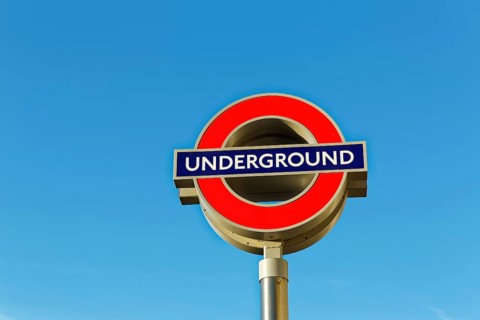 Underground signboard against blue sky