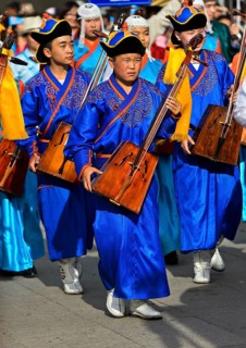 Youth in traditional Deel clothes and horse-head fiddle