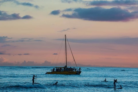 Evening light over sailing boat at Waikiki Beach