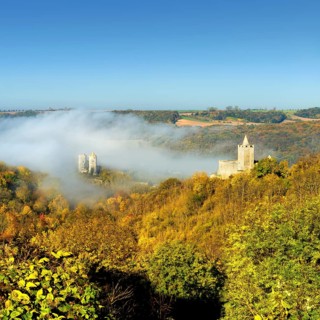 Castle ruins Saaleck and Rudelsburg in the autumn morning mist in the Saaletal valley