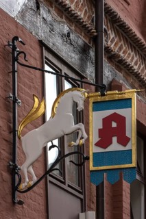 Hanging shop sign of the Unicorn Pharmacy