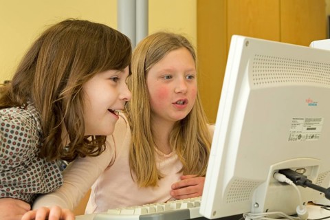 Elementary school girls working in computer room