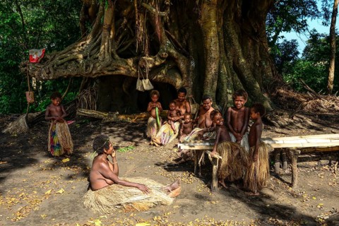 Native women and children sitting together