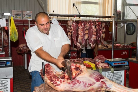 Butcher cutting meat