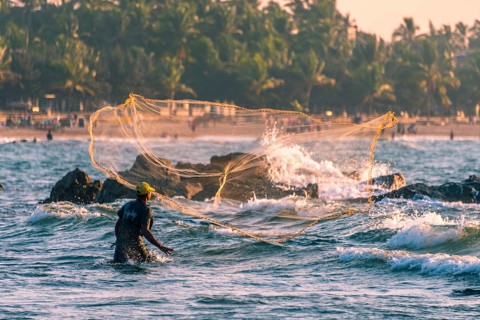 Local fisherman casts fishing net