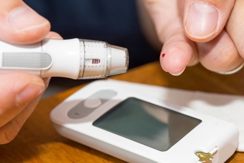 Diabetics taking a blood glucose test
