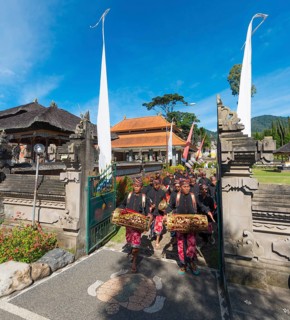 Procession of devout Buddhists at water temple Pura Ulun Danu Bratan water temple