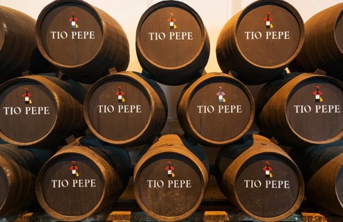 Stacked oak barrels with the famous Tio Pepe sherry