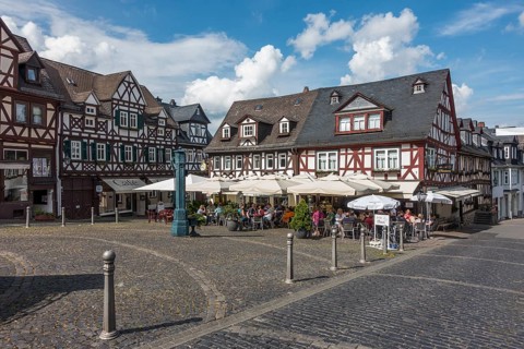 Market square with half-timbered houses and historic water pump