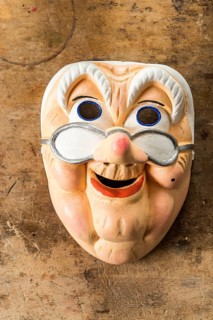 Painted wooden mask on a workbench
