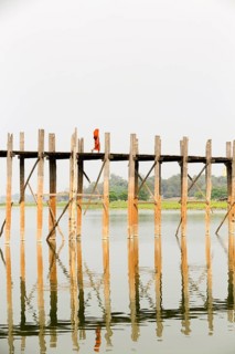 Monk crossing U Bein bridge