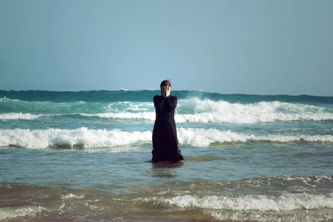 Woman in black dress with mask