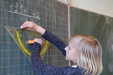 Student calculating on the blackboard