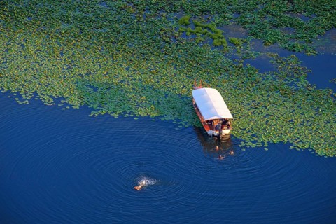 Boat and bathers in the river Rijeka Crnojevica