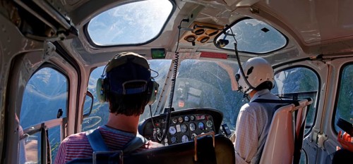Helicopter cockpit with pilot and passenger in flight to Mount Cook