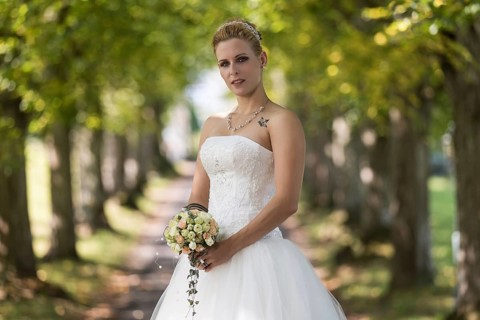Young blonde woman in a white wedding dress