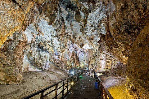 Boardwalk through illuminated dripstone cave