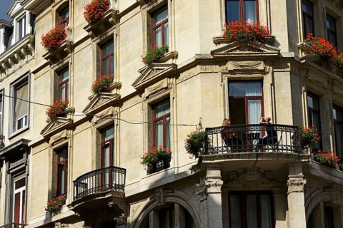 Young woman having breakfast on the balcony