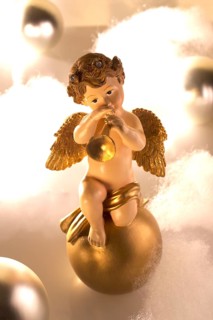 Ceramic angel figure plays trumpet