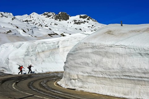 Two skiers in front of high snow walls