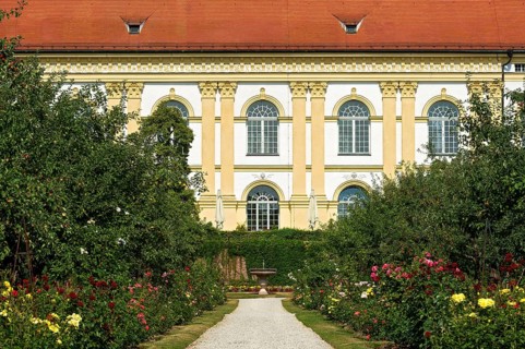 Colorful flower beds in front of castle facade