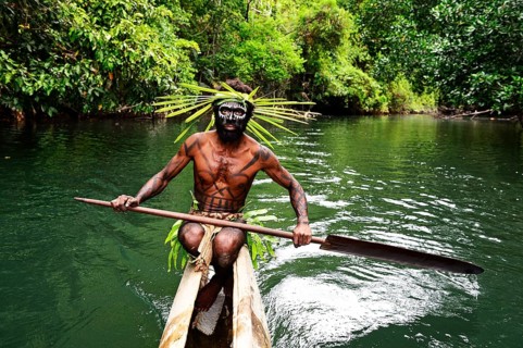Korafe-Man paddling in a dugout boat