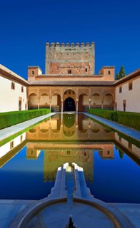Arabesque Moorish architecture and pond of the Court of the Myrtles of the Palacios Nazaries