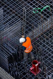 Construction workers processing reinforcing steel for reinforced concrete ceiling