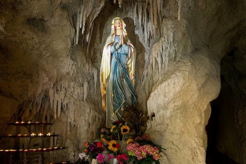 Lourdes grotto with a statue of the Virgin Mary