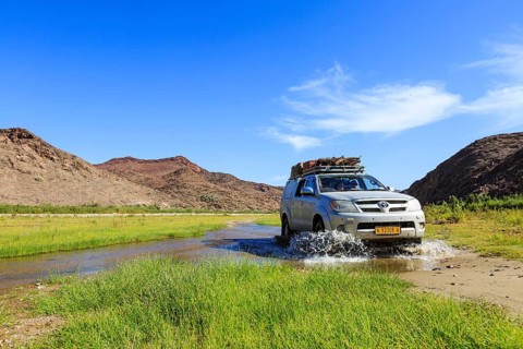 Off-road vehicle crosses Hoarusib River