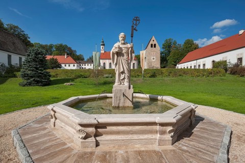 Monastery church with Roman tower and fountain with fountain figure of abbot Walto or Balto