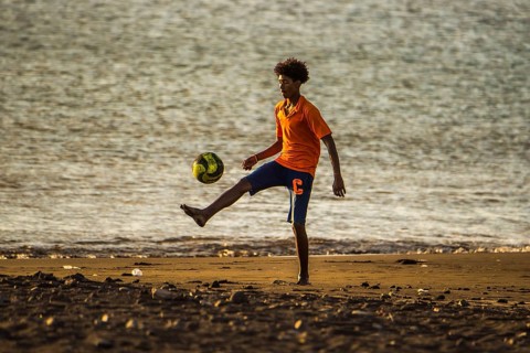 Teenager playing soccer
