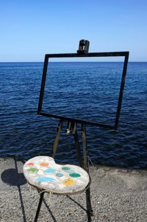 Easel and pallet in front of the sea