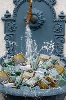 Counterfeit money in fountain with water running