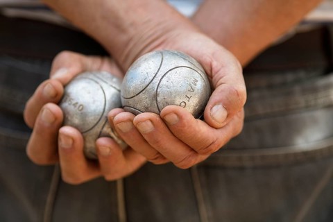 Male hands holding Petanque balls