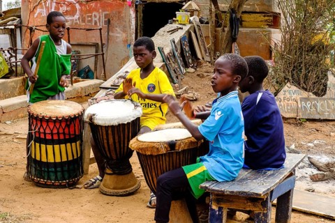 Senegalese children make music with drums