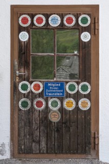 Stable door with milk yield plaques