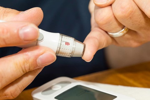 Diabetics taking a blood glucose test